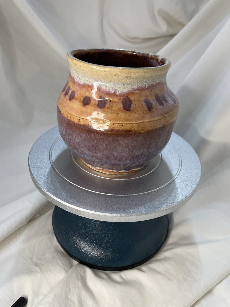 small pot glazed in purple with purple dots